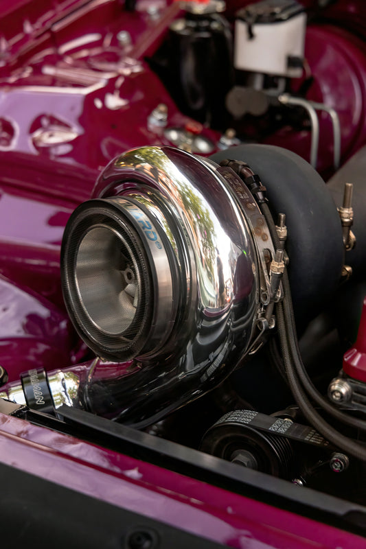 Close-up of a shiny chrome turbocharger on a car engine
